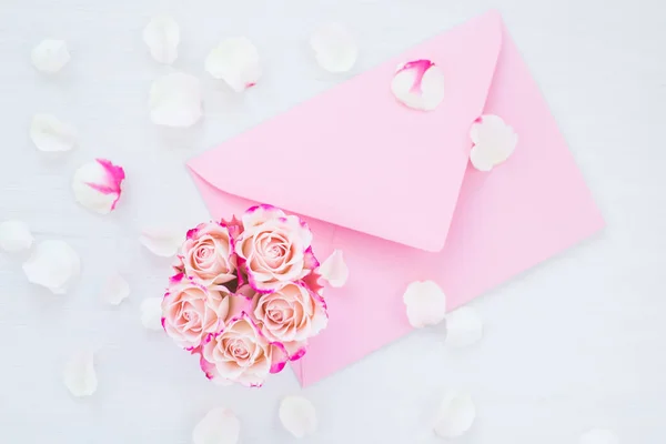 Framework of pink roses and gifts. Spring concept, flat lay, copy space