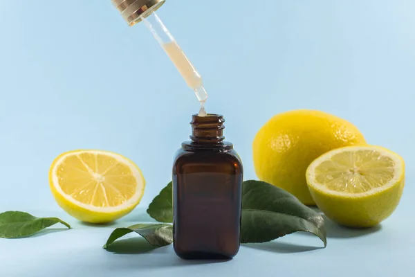 Suero de vitamina C. Cierre la pipeta con la gota, aceite esencial de cítricos. cuidado de belleza. Aceite bio de limones frescos. Cosméticos biológicos orgánicos con vitamina C. Suero de vitamina C. Crema con vitamina C. Copiar el espacio Imágenes De Stock Sin Royalties Gratis