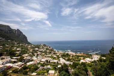 Mavi gökyüzü ile muhteşem bir manzara. Binanın ön planında. Arka planda bir göl var. Capri, İtalya