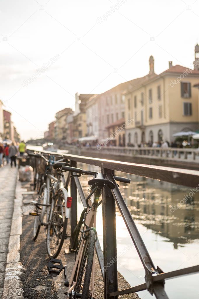 Bicycles parking at the Naviglio Grande with building along the 