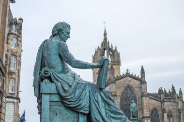 David Hume Statue with St. Giles Cathedral on the background on Royal Mile in Edinburgh, Scotland clipart