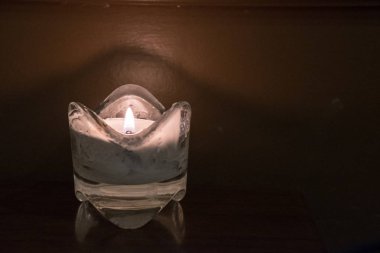 Candle in a clear glass clipart