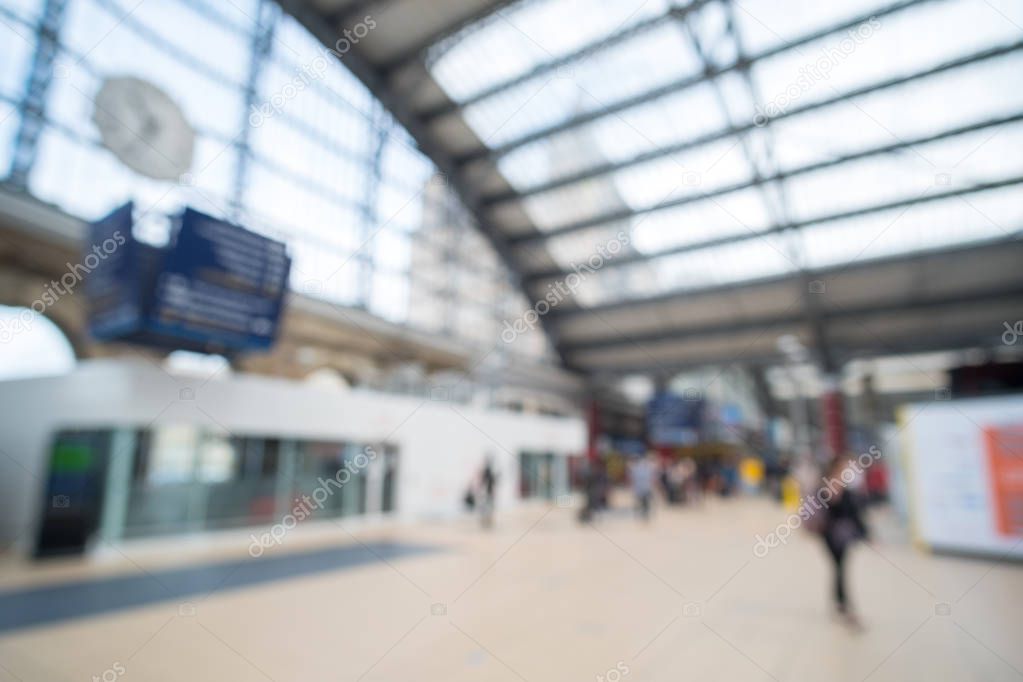 Blurred image bokeh of People walking inside Liverpool Lime Street Train Station.