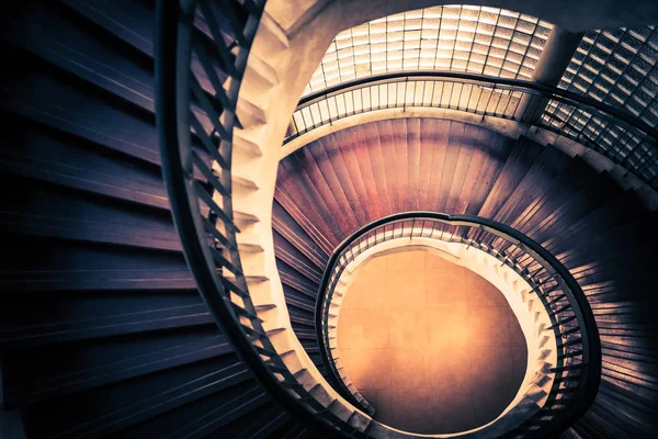 Staircase in spiral or swirl shape, fibonacci golden ratio composition, abstract or architecture concept, dark vintage mysterious tone Stock Picture