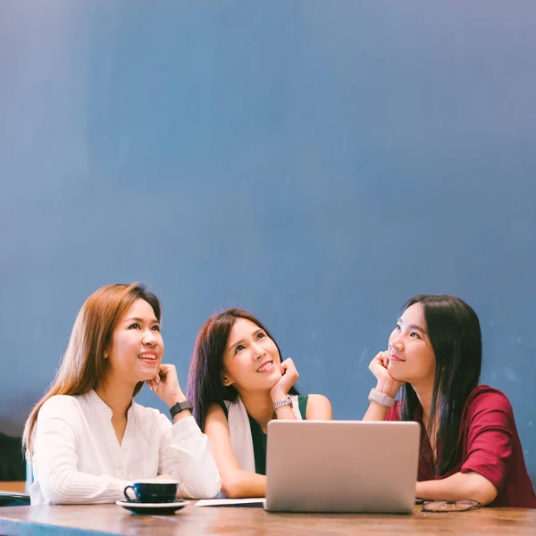 Tres hermosas chicas asiáticas mirando hacia arriba para copiar espacio mientras trabajan en la cafetería, estilo de vida moderno con tecnología de gadget o mujer trabajadora en concepto de negocios casuales — Foto de Stock
