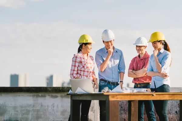 Multiethnic diverse group of engineers or business partners at construction site, working together on building's blueprint, architect industry or teamwork concept — Stock Photo, Image