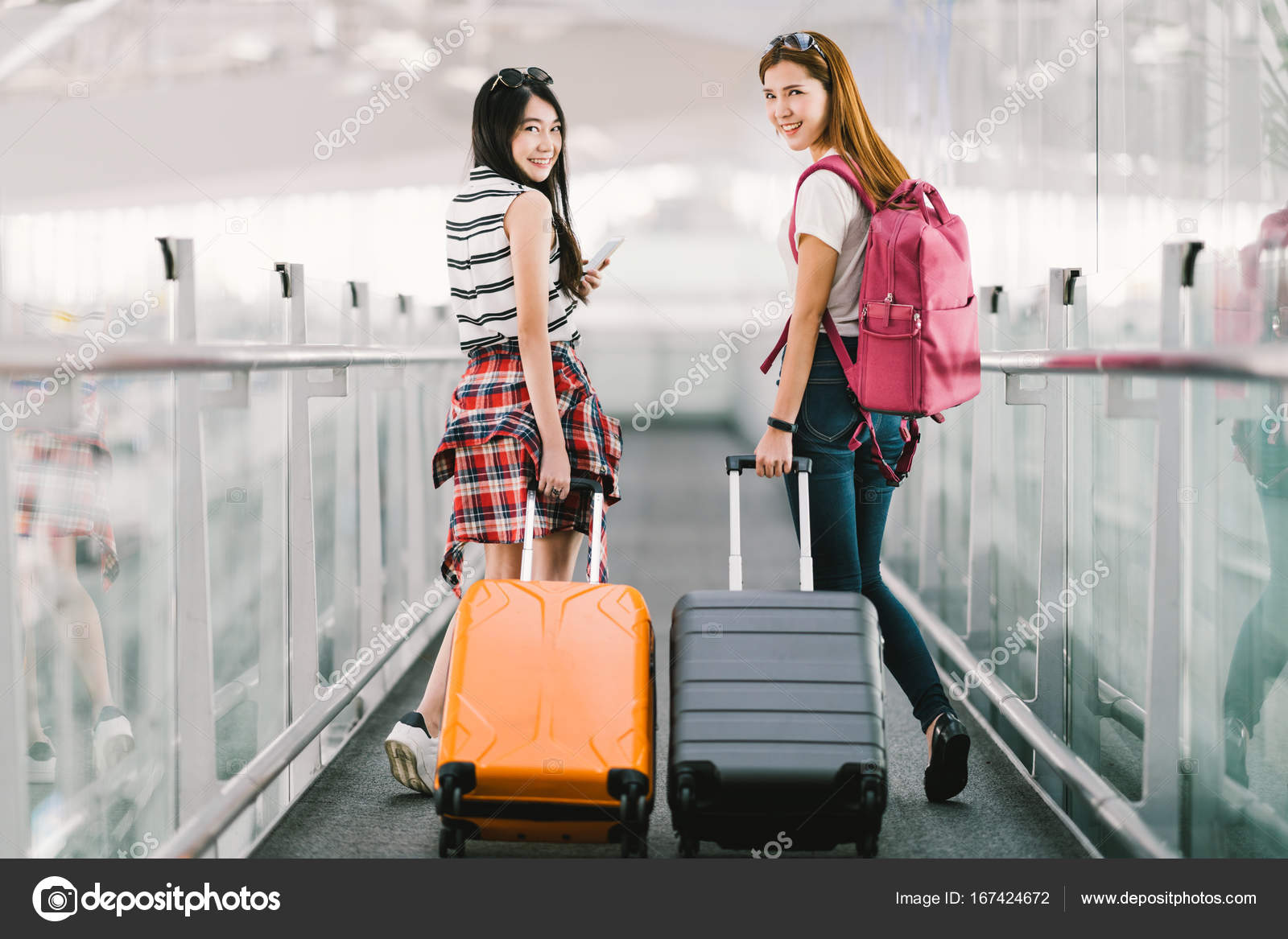 asian girl carrying suitcase