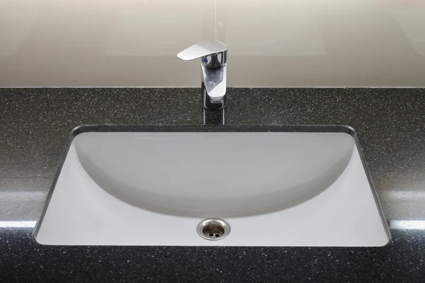 Modern style faucet with black granite counter top