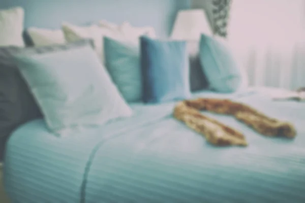 Blur image of scarf on bed in blue color scheme bedding — Stock Photo, Image