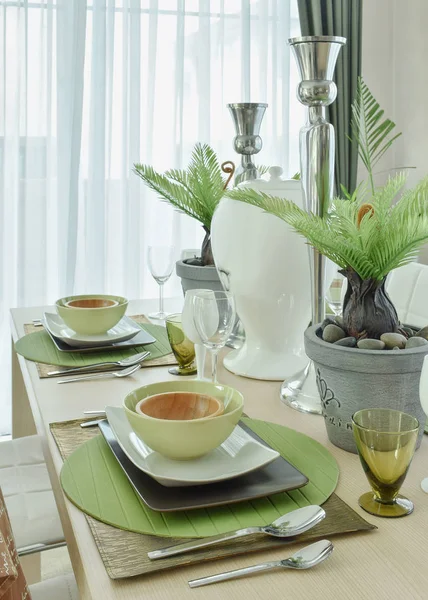 Beautiful modern ceramic tableware in green color scheme setting on dining table — Stock Photo, Image