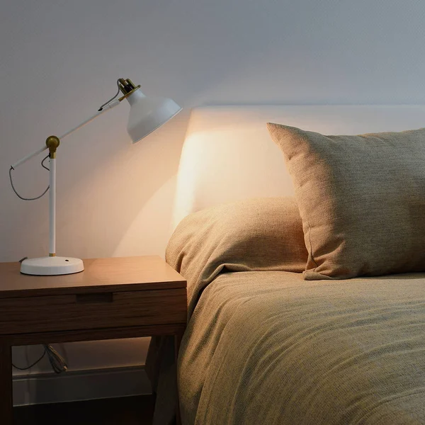 bedroom interior with reading lamp on bedside table