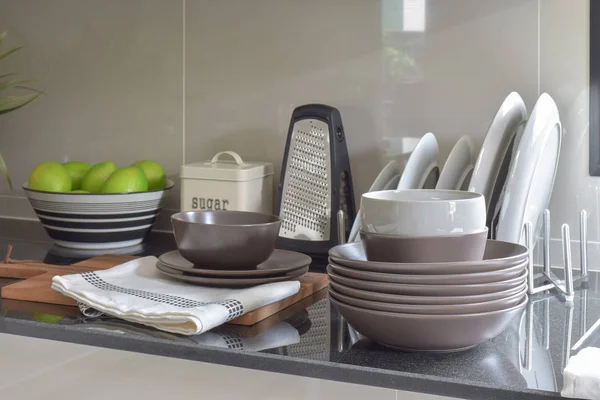 Deep brown ceramic set on black granite top counter — Stock Photo, Image