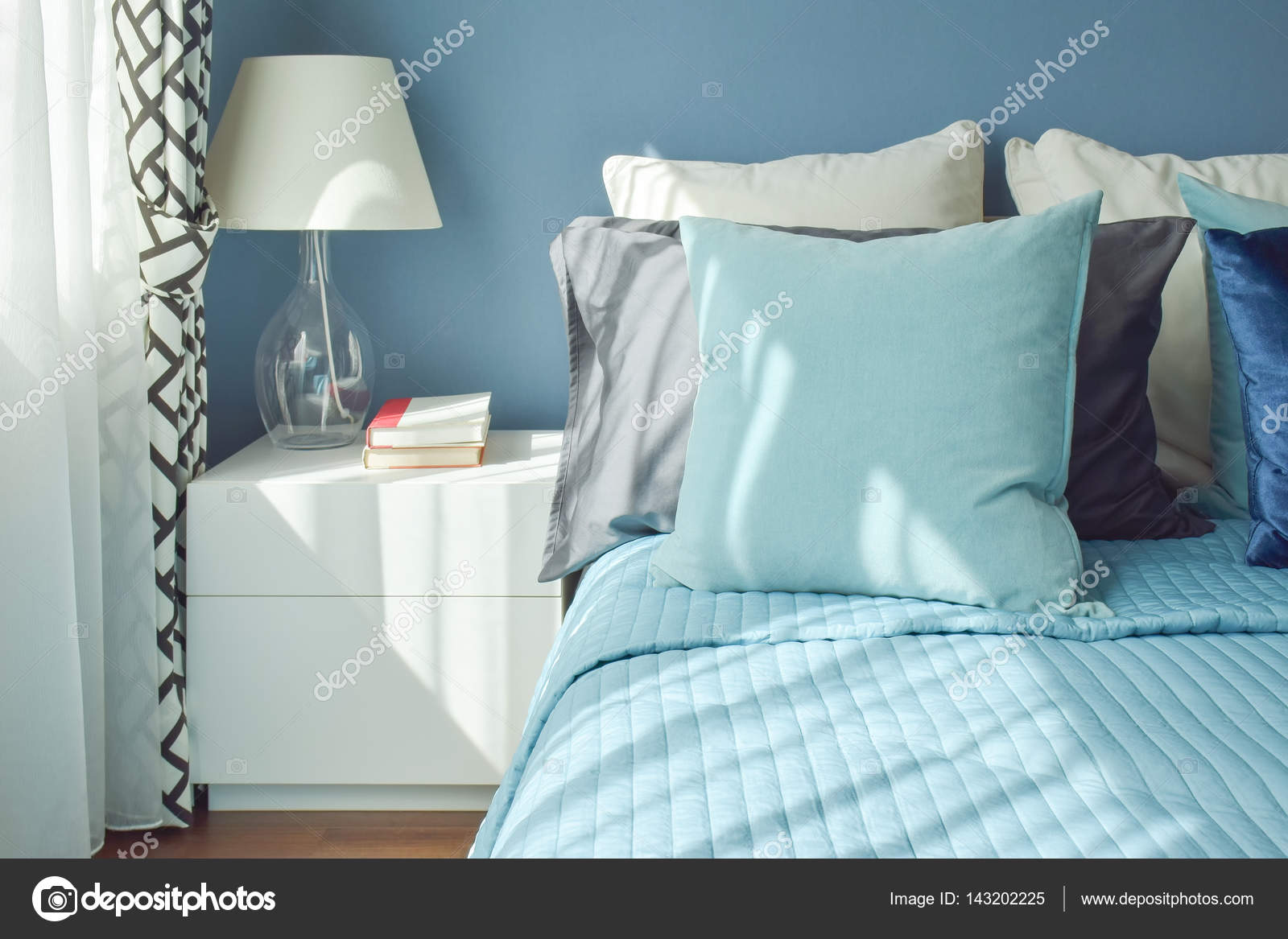 Blue Color Scheme Bedding And White Table Lamp With Natural Ligh Blue Color Scheme Bedding And White Table Lamp With Natural Ligh Stock Photo