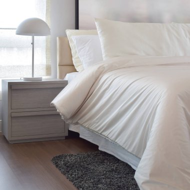 Yastıklar ve okuma lâmbası başucundaki ile rahat yatak odası iç