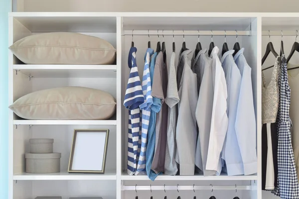 Modern closet with row of cloths hanging in white wardrobe — Stock Photo, Image