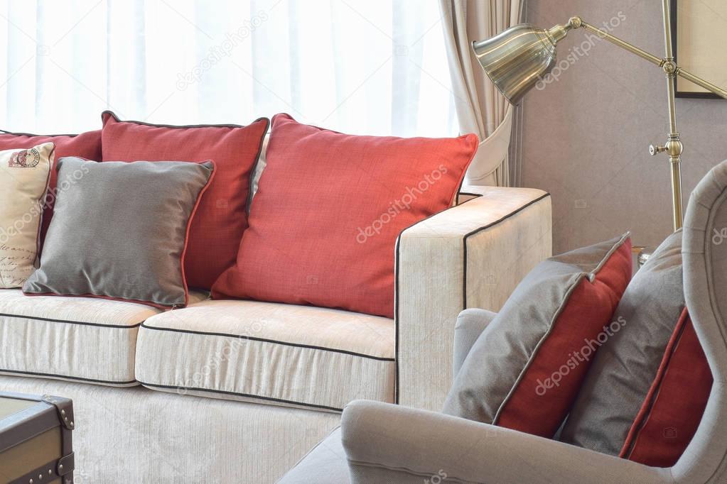 Classic industrial look living room with beige sofa and red and pillows