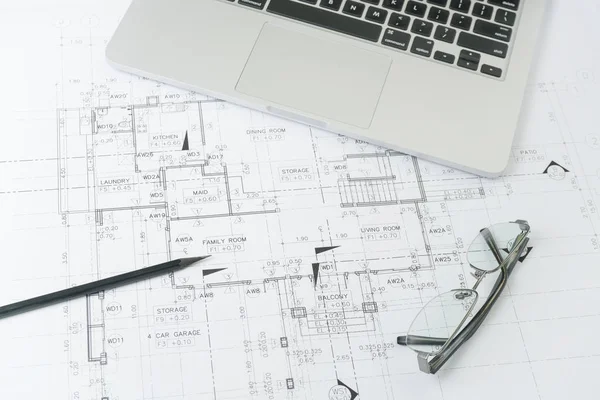 Black pencil and computer laptop on architectural drawing paper for construction — Stock Photo, Image