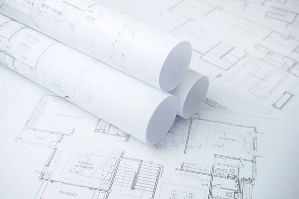 Architectural drawing paper rolls of a dwelling for construction Royalty Free Stock Images