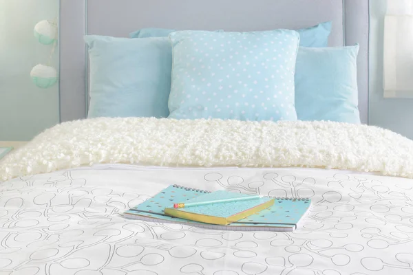 Light blue notebooks setting on beige color blanket with light blue interior bedroom — Stock Photo, Image