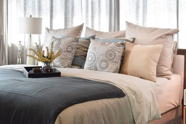 Luxury bedroom interior design with striped pillows and decorative tea set on bed — Stock Photo, Image