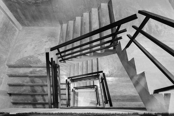 Empty modern rough concrete stairway with black steel handrail