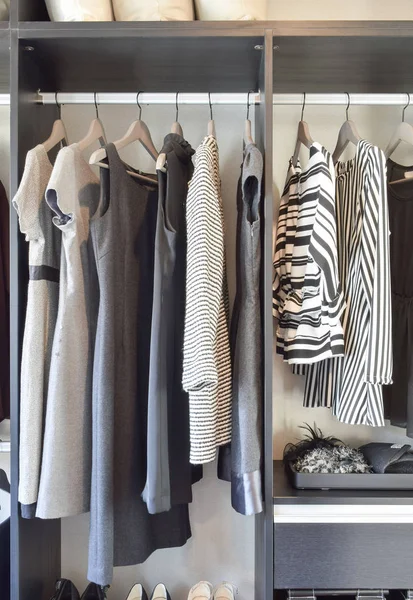 Modern closet with row of black dress and shoes in wardrobe. — Stock Photo, Image