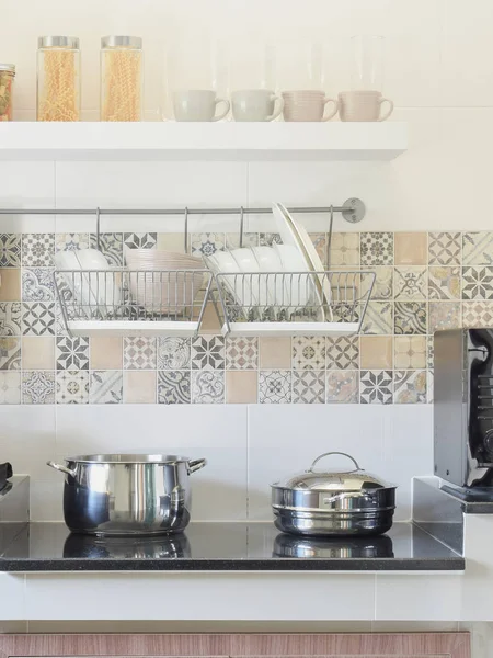 Modern ceramic kitchenware and utensils on the black granite counter top — Stock Photo, Image