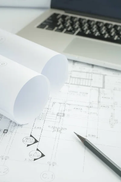 Black pencil and computer laptop on architectural drawing paper — Stock Photo, Image