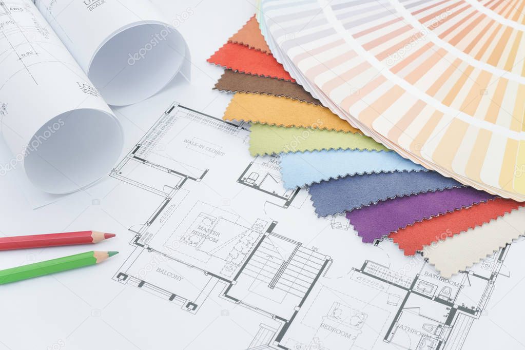 Interior designer working desk with drawing, fabric sample, color pencil and color palette