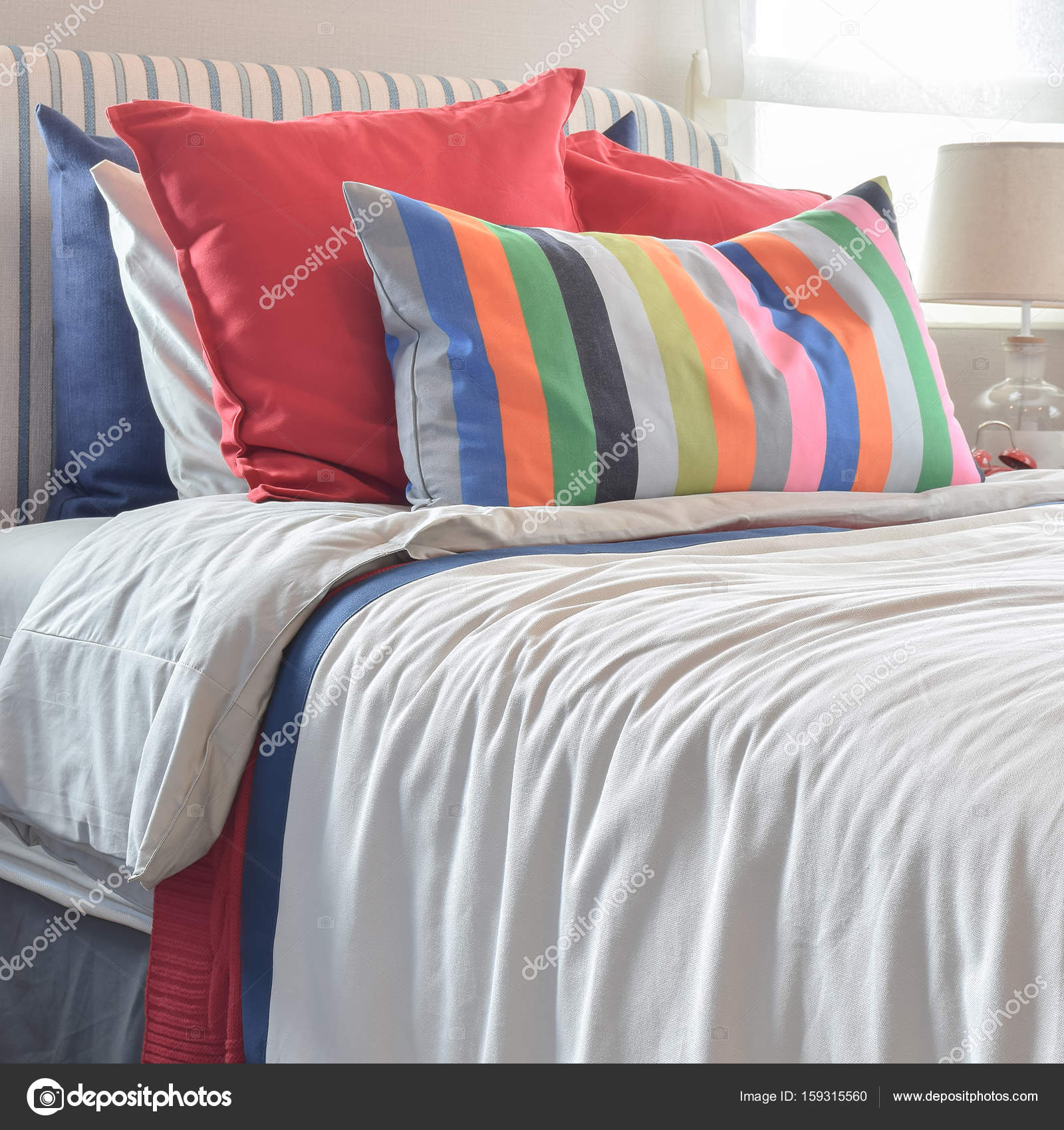 White bed top colorful pillows