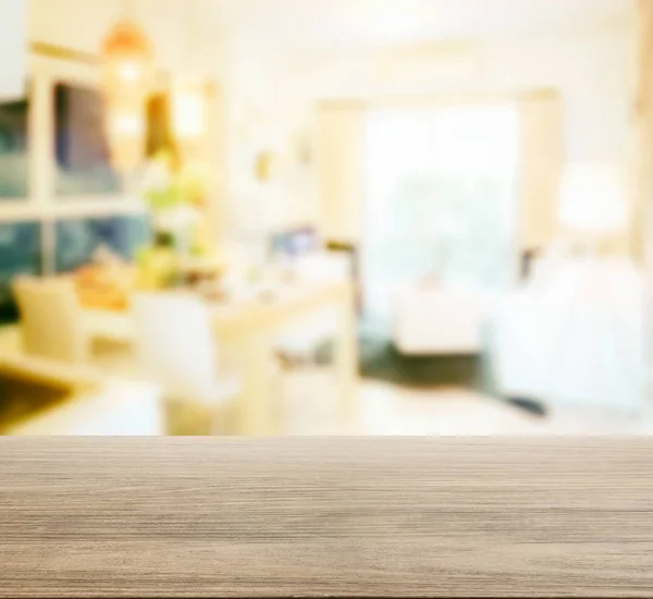 Wooden table top with blur of dining table in modern dining room interior — Stock Photo, Image