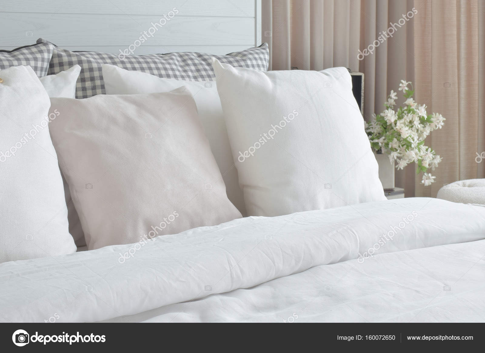 Off white pillows setting on bed with english country style bedding
