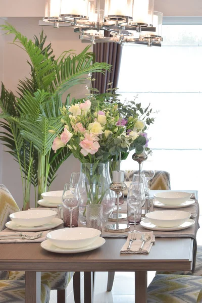 Gorgeous dining set on wooden table with beautiful chandelier