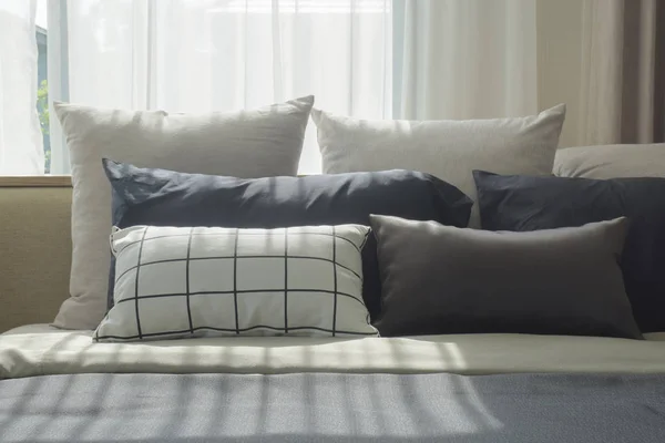 Varies size of pillows setting on bed with natural light in bedroom — Stock Photo, Image