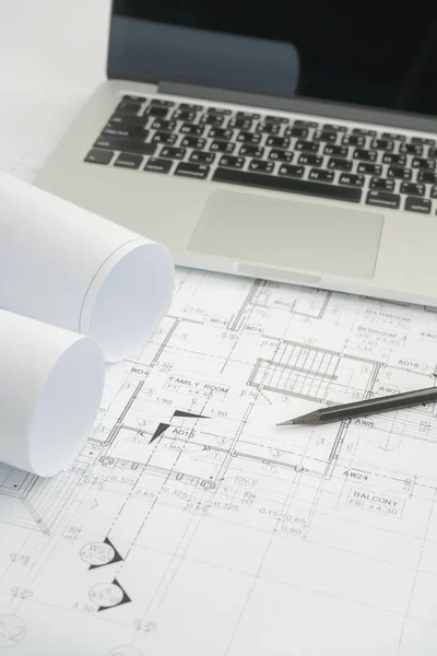 Black pencil and computer laptop on architectural drawing paper for construction — Stock Photo, Image