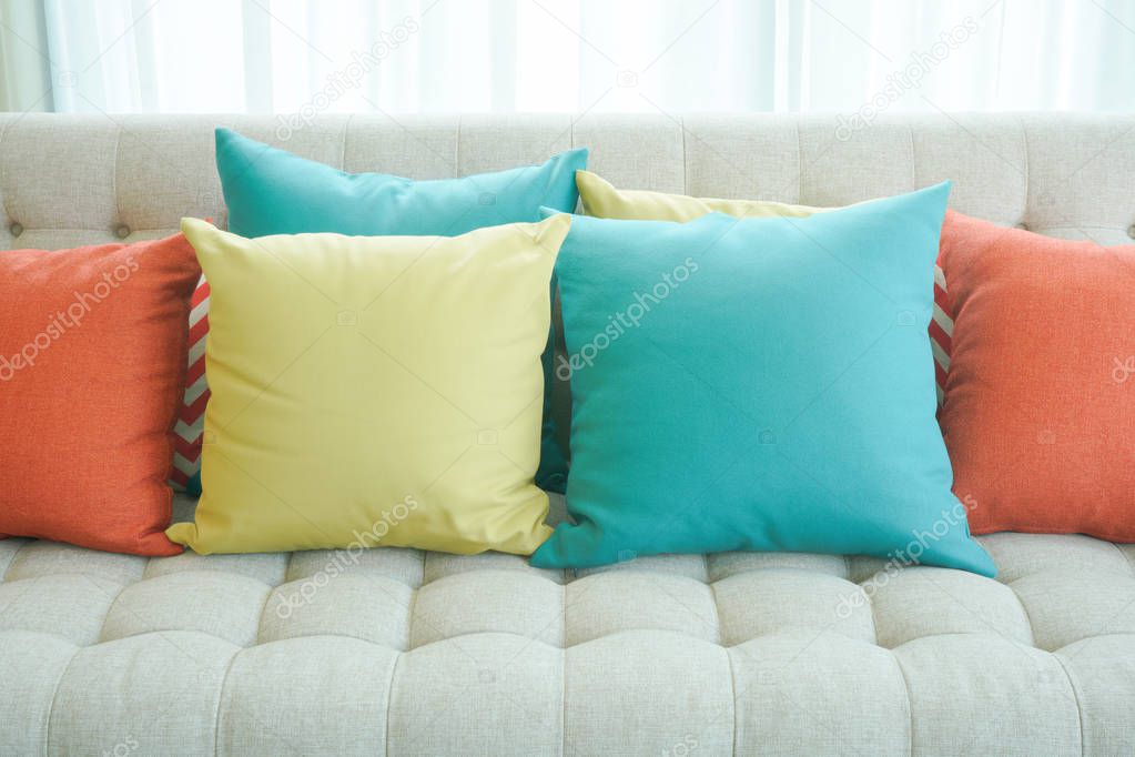 Closeup colorful pillows on sofa in living room