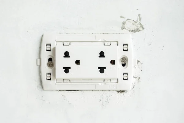 The electric socket with no cover plate on unfinish wall at construction site
