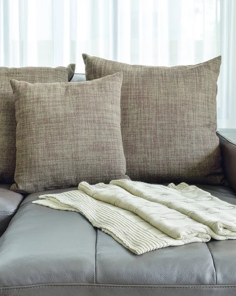 Sofá de cuero gris con almohadas de textura marrón en la sala de estar moderna — Foto de Stock