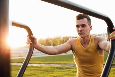 Adam stadyum bölgesinde güneş arka plan ile egzersiz yapmak