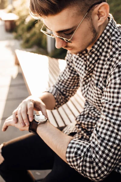 Fashionable man look at watch  with white background street