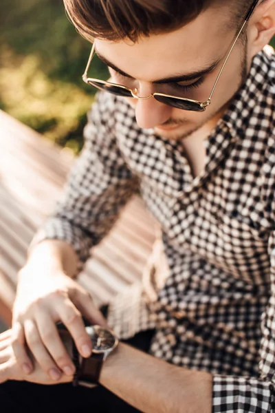 Fashionable man look at watch  with white background street