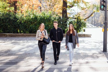 Üç arkadaş sokakta yürümek