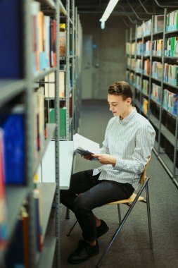 Kütüphane ve okuma kitap ile adam oturup arka plan bulanıklık