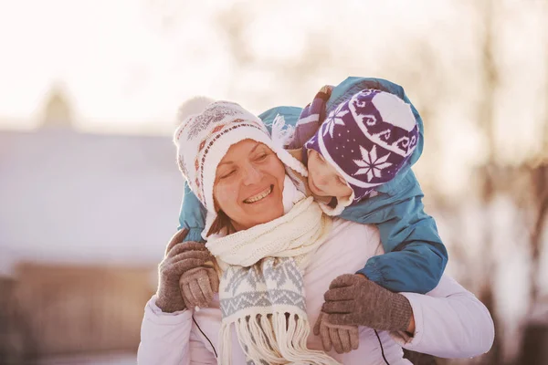 Happy family mother and child sun having fun, playing at winter — Stock Photo, Image