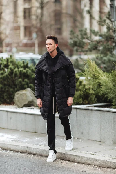 Stylish man wolk on the street. Winter cold outfit. Big jacket w Stock ...