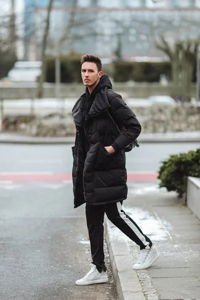 stock image Stylish man wolk on the street. Winter cold outfit. Big jacket w