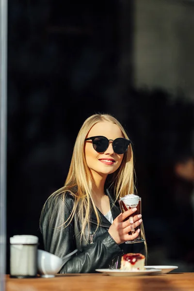 Menina bonita segurar uma xícara de café delicioso e óculos de cintura. Sol — Fotografia de Stock