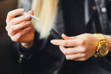 Dava ile elektronik sigara kadar kapatın ve kız backgro üzerinde bulanıklık