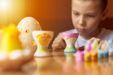 Küçük çocuk yumurta bulanıklık arka plan ve polis tablo çizmek