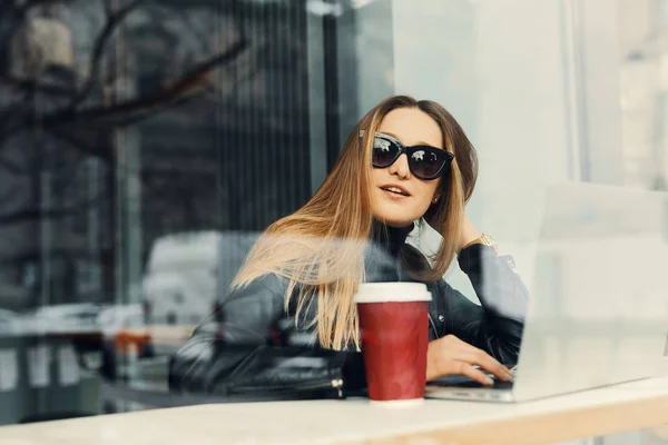 Giovane ragazza sedersi in un posto di caffè di fronte alla finestra guardare lui — Foto Stock